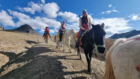 Group of travelers doing the Ausangate Horseback Trek across high mountain trails
