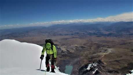 Reaching the summit of Ausangate snow-capped mountain
